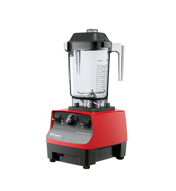 Commercial blender in a busy kitchen, blending frozen fruits and vegetables.